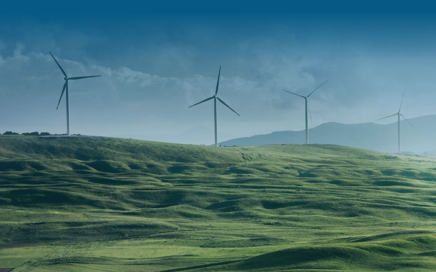 A set of windmills in an open field.