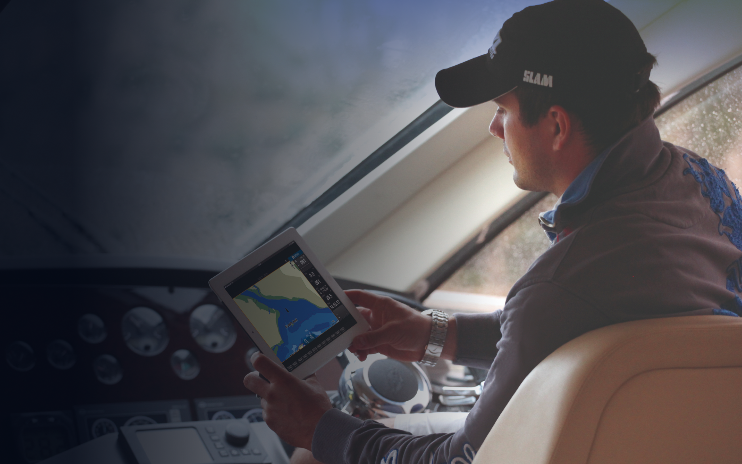 A person using a C-MAP app on a tablet.