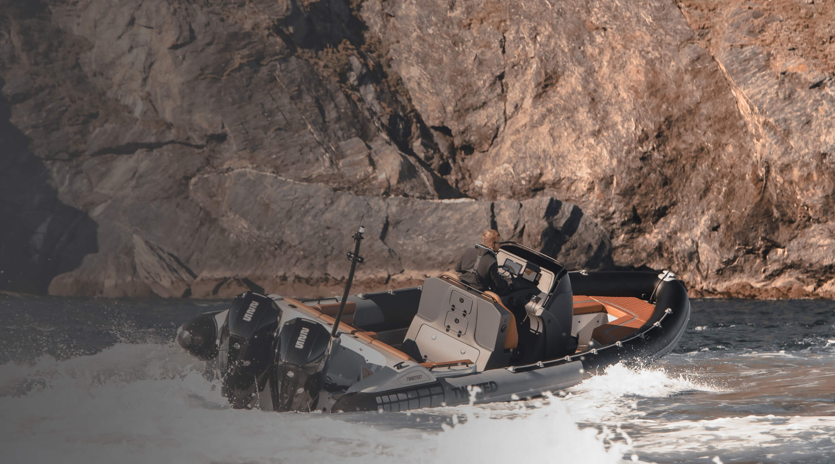 A person driving a fishing boat. 