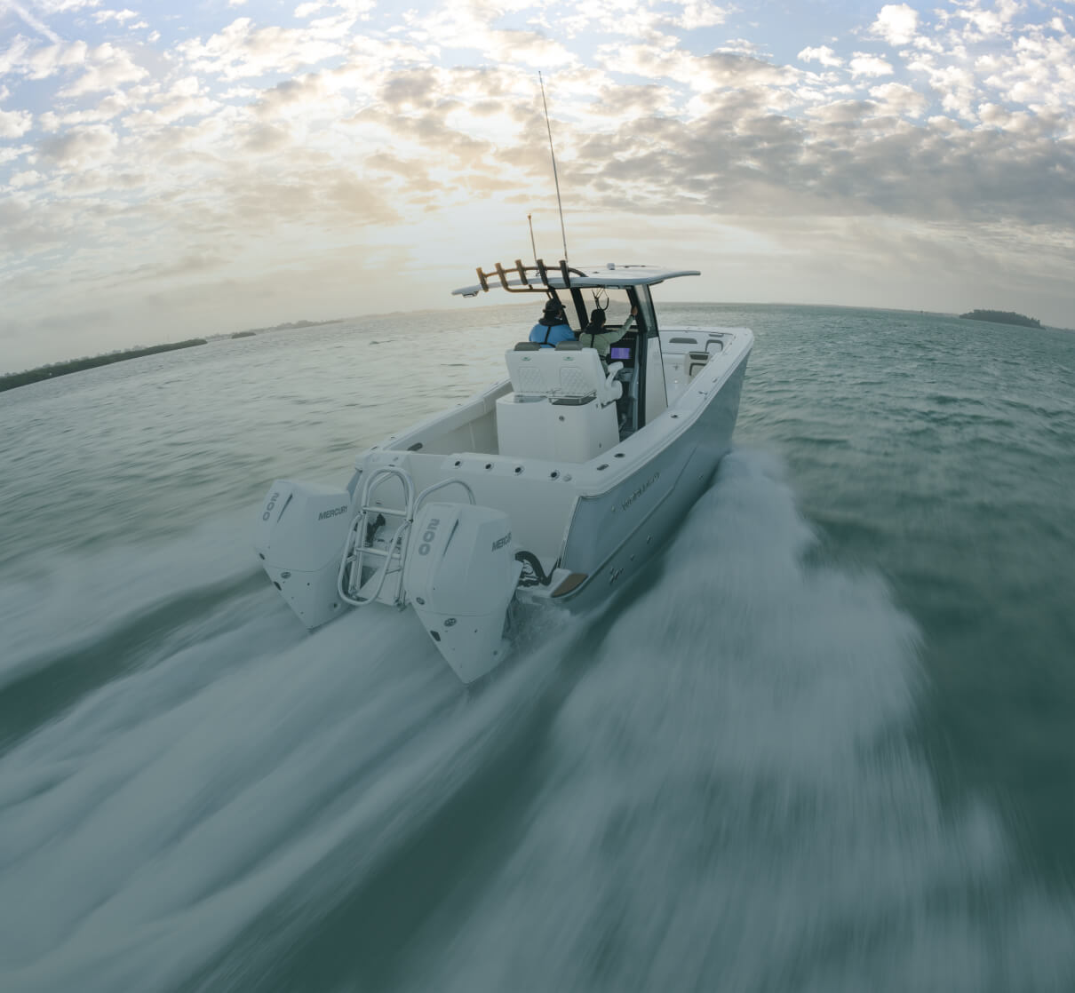 A fishing boat driving across the water.