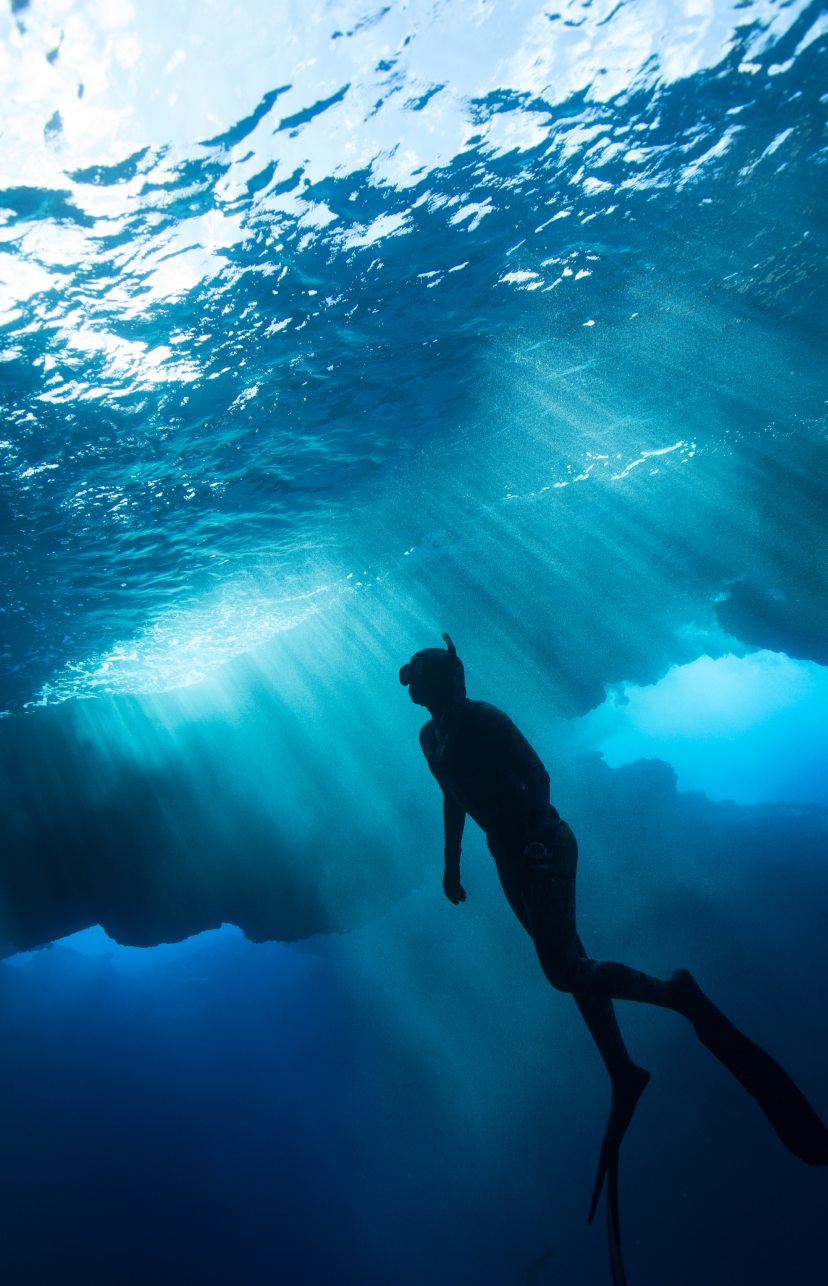 A person swimming underwater.