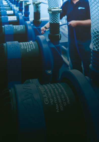 A person working with water pumps and heating systems.